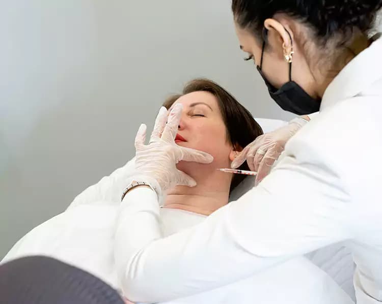 Doctor treating a patient's jawline